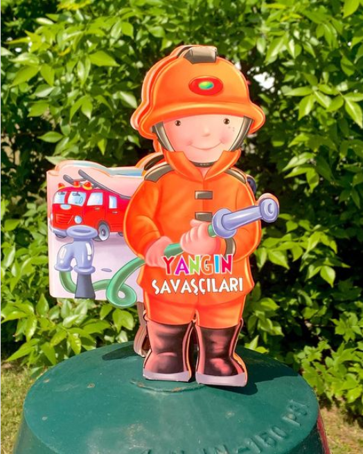 This die cut book has been cut into the shape of a small fireman. The fireman is a creative book that uses imagination to make the book come to life. 